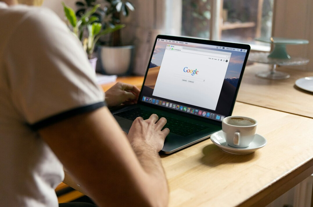 person coding on laptop at home